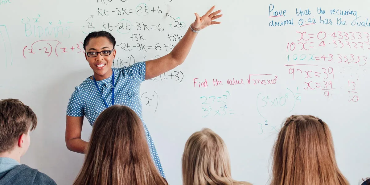 A teacher exemplifying one of the 10 essential classroom management skills as her class is focused and organised.